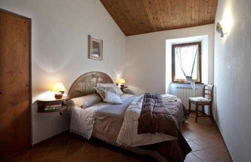 古比奥丰泰阿尔诺斯乡村民宿的一间卧室设有一张床、一个窗口和一把椅子