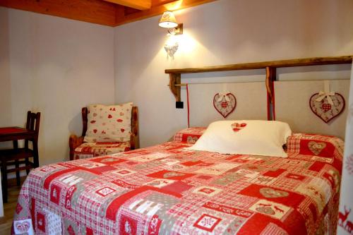 努斯La Maison De Toyen的一间卧室配有一张带红白色棉被的床