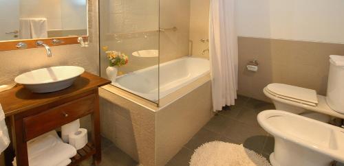 圣卡洛斯-德巴里洛切苏尔滑雪公寓酒店的一间带水槽、浴缸和卫生间的浴室