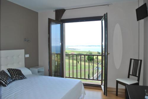 朗格勒朗格艾尔瑞博德酒店的一间卧室设有一张床和一个美景阳台