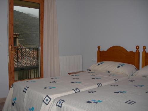 卡马雷纳德拉谢拉Apartamentos Turísticos Rosario的一间卧室设有一张床和一个美景窗户。