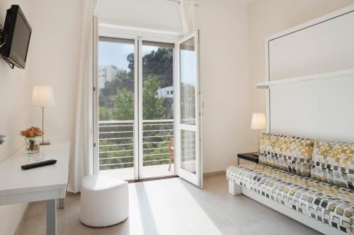 马奥莱甜蜜生活公寓酒店的白色的客房设有沙发和窗户。