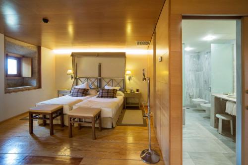 Santo Estevo de Rivas de Sil圣艾斯特沃旅馆的一间带大床的卧室和一间浴室