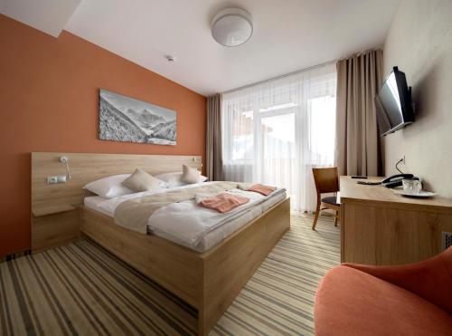 扎兹里瓦哈瓦尼亚酒店的配有一张床和一张书桌的酒店客房
