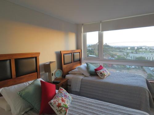 Concepción Suites客房内的一张或多张床位