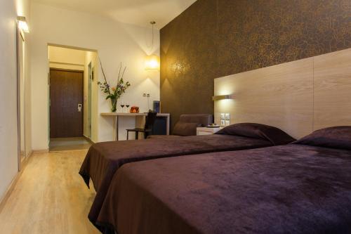 塞萨洛尼基罗托达酒店的酒店客房配有两张床和一张书桌