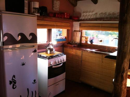 德尔迪阿布罗角艾伦德诺斯度假屋的厨房配有炉灶和冰箱。