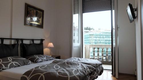 的里雅斯特B&B Piazza Goldoni的一间卧室设有一张床和一个大窗户