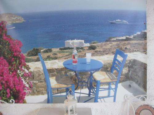 帕罗奇亚梅莱蒂斯公寓酒店的蓝色的桌椅,享有海景