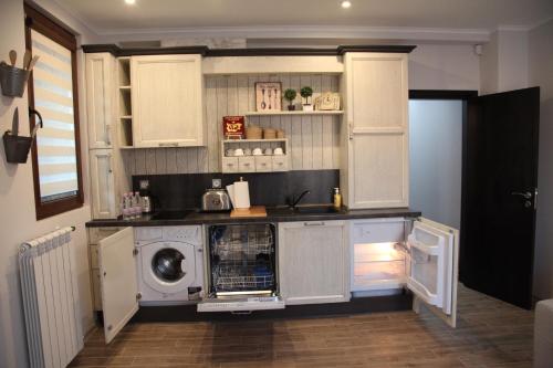 多布里奇Apartment Retro的厨房配有白色橱柜、洗衣机和烘干机