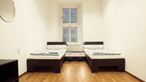 布拉迪斯拉发乡亲旅馆的客房设有两张床和窗户。