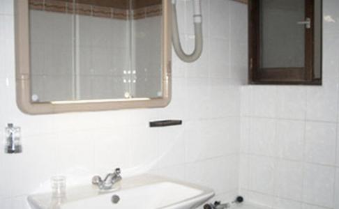 巴黎阿文尼尔酒店的白色的浴室设有水槽和镜子