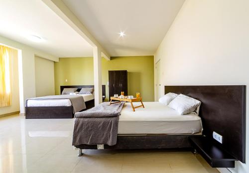 齐克拉约桑塔别墅旅馆的一间卧室配有两张床和一张桌子