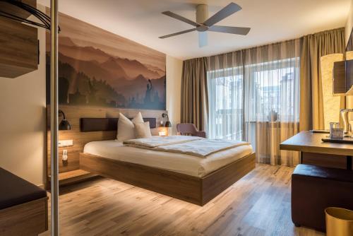 慕尼黑巴伐利亚精品酒店的酒店客房配有一张床和吊扇。