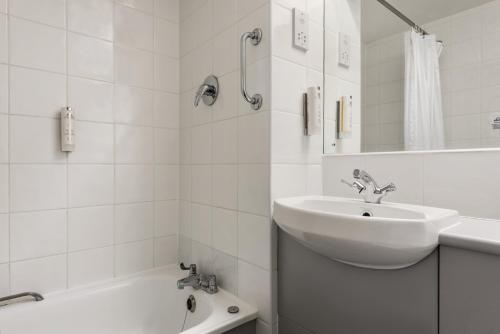 布里真德戴斯加的夫布里真德酒店的白色的浴室设有水槽和浴缸。