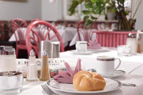 埃朗根埃朗根艺术酒店的一张桌子,上面有一块带牛角面包的盘子