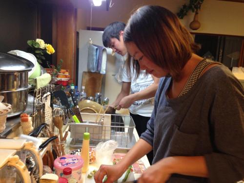 Mino蕨旅馆的两个人站在厨房准备食物