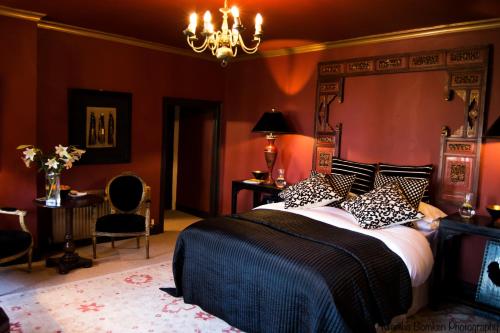 奥克姆The Fox and Hounds的一间卧室设有一张带红色墙壁的大床