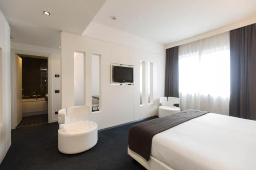 罗马iH Hotels Roma Z3的一间酒店客房,配有一张床和一台电视