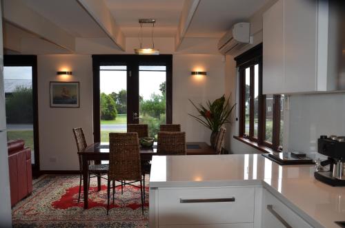 Adventure Bay约拉海滨别墅 的厨房配有桌椅和窗户。