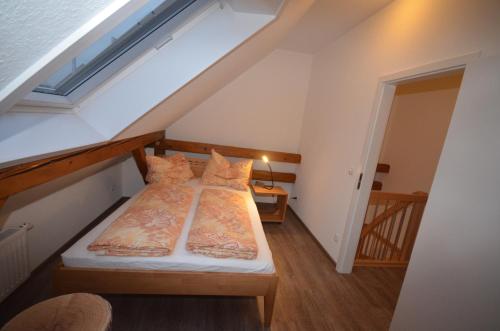MehrhoogFerienwohnung Hagener Meer的阁楼卧室设有两张床和楼梯。