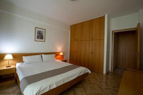 朱尼耶Adma Blue Screen的一间卧室配有一张大床和一个木制橱柜