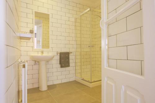 埃里塞拉阿马尔套房旅馆的白色的浴室设有水槽和镜子