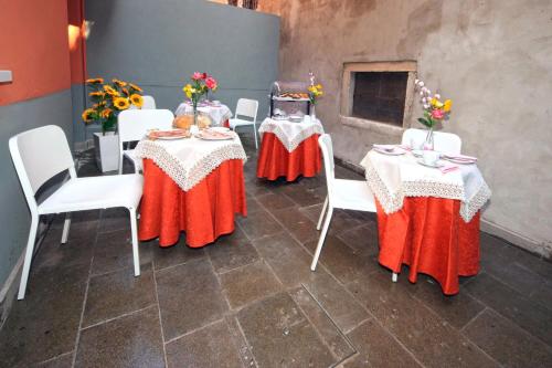 威尼斯里亚托梦幻住宿加早餐旅馆的一组桌子,上面有白色的椅子和鲜花