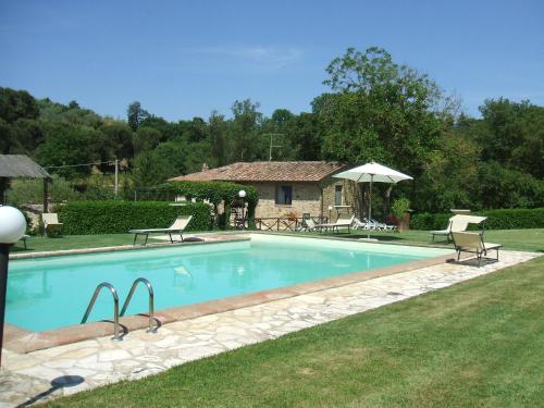 桑塔比诺Borgo del Molinello的一个带椅子的游泳池以及一座房子