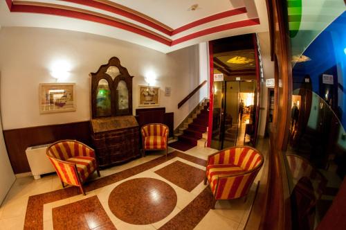 加尔达湖滨普里莫酒店的一间带椅子和桌子的房间以及壁炉
