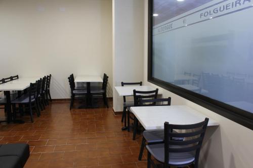 波尔托马林Albergue Folgueira的用餐室配有桌椅和投影屏幕