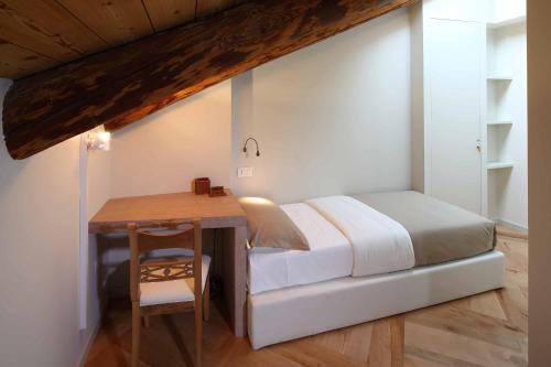 马洛安德安娜酒店的一间卧室配有一张床和一张木桌