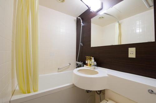 宇都宫宇都宫市岐山酒店 的浴室配有盥洗盆、镜子和浴缸