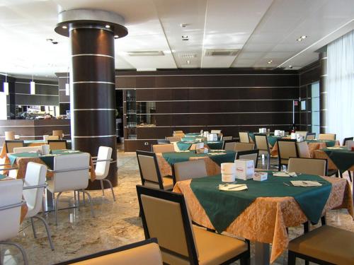 帕尔马达都国际酒店的一间带桌椅和壁炉的用餐室