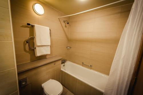 索兹罗根镇酒店及乡村俱乐部的带浴缸、卫生间和盥洗盆的浴室