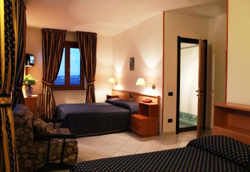 奇斯泰尼诺绿宝石酒店的酒店客房设有两张床和窗户。