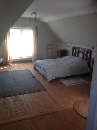 维莱尔维尔Les Grands Houx的一间卧室设有一张床和一个大窗户