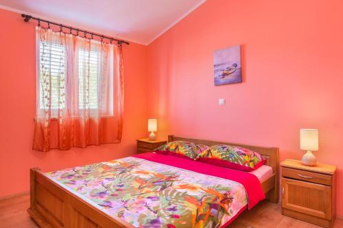 梅杜林Apartments Villa Orange的一间卧室配有一张带橙色墙壁和窗户的床
