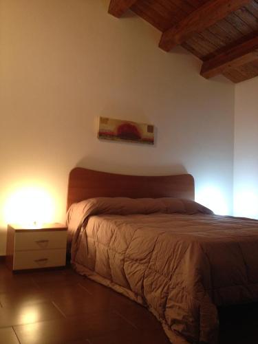 拉古萨Casa Vacanze Agriturismo Cilone的卧室配有一张床,墙上挂有绘画作品