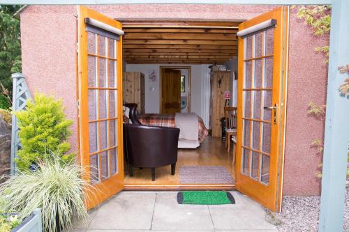 阿布罗斯Kirkstyle Hideaway的一间设有一扇门的客房,可通往一间卧室