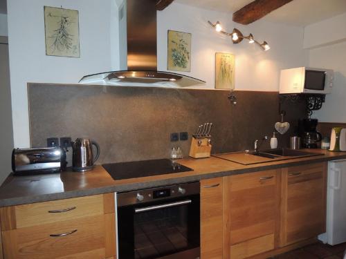 Saint-MontanLe Mouleyras的厨房配有水槽和炉灶 顶部烤箱