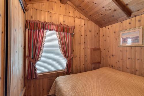 WillisLake Conroe One-Bedroom Cabin 3的一间位于小屋内的卧室,配有一张床和一个窗户