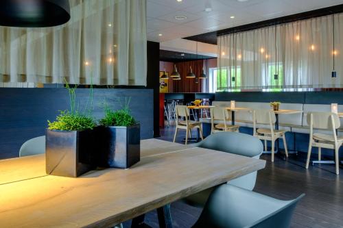 巴勒鲁普伯乐奥普兹利普酒店的餐厅设有木桌、桌椅