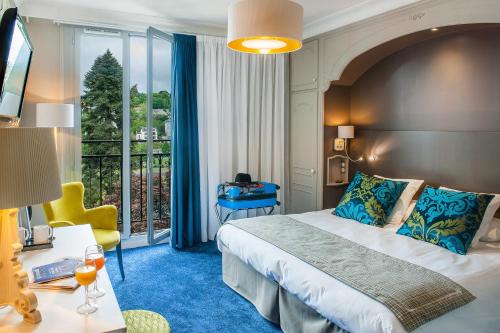 卢尔德Grand Hôtel Gallia & Londres Spa NUXE的酒店客房设有一张床和一个阳台。