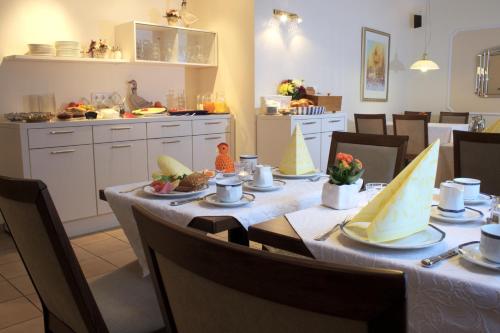 利普施塔特Hotel-Pension Pöhling的用餐室配有餐桌和食物