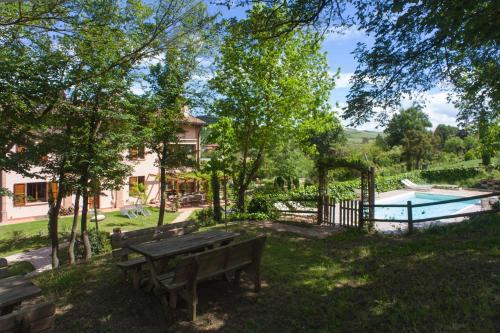 皮亚诺罗卡维奇奥乡村民宿的一个带长凳和游泳池的公园