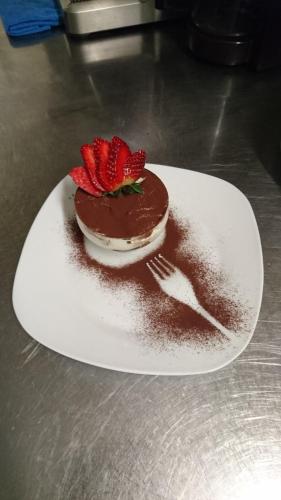 吕德斯海姆索马山酒店的一块带叉子的白板上的巧克力蛋糕