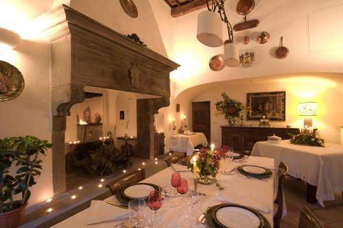 马拉迪帕拉佐托里亚尼酒店的用餐室设有2张桌子和白色桌布,并可能令客人感到愤怒