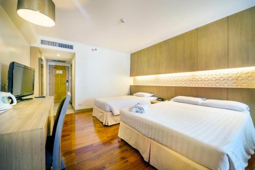 乔木提恩棕榈滩度假酒店 - SHA Extra Plus客房内的一张或多张床位