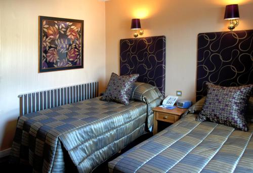 阿伯丁克莱格哈尔酒店的酒店客房设有两张床和一张桌子上的电话